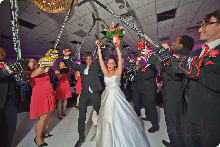 couple enter the reception hall in a hockey theme