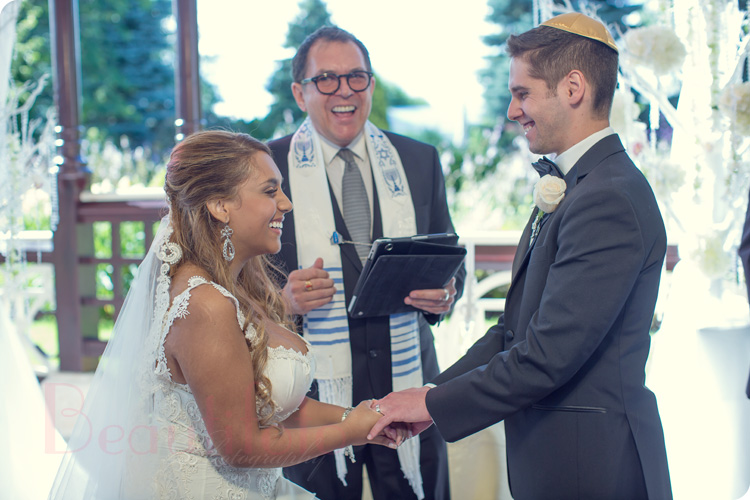 fun moment white the groom and bride exchange vows at a montreal jewish wedding
