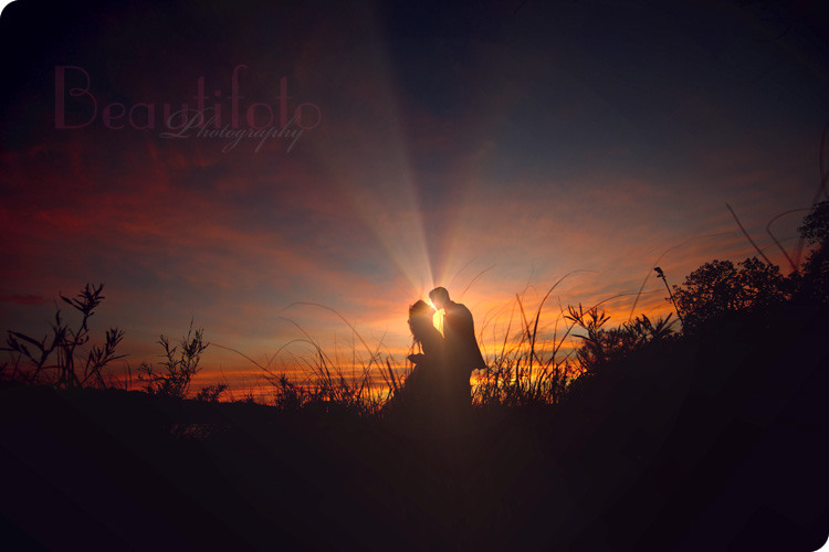 a portrait of the couple kissing at sunset during a trash the dress session