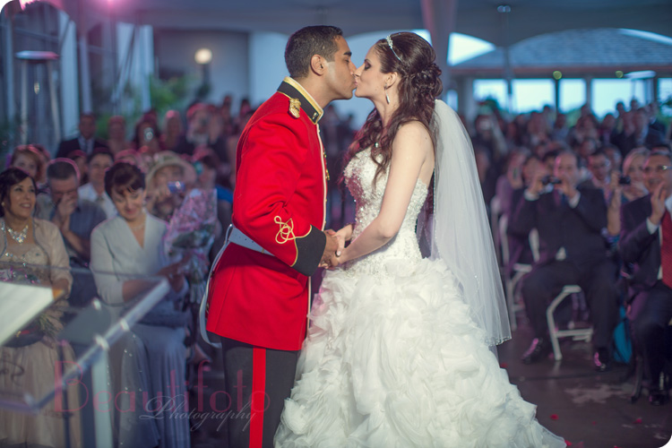 the bride and groom kiss. Captain Major in the canadian army shot by Beautifoto Montreal wedding photography
