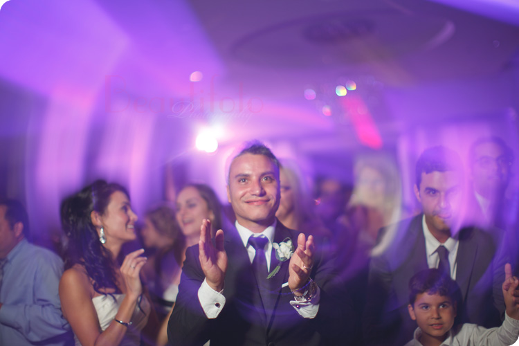 The groom clapping to a song during the party at the reception hall. Photo by Beautifoto Montreal wedding photographer.