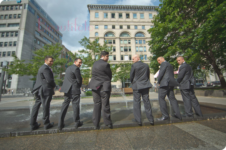 The groom's men pretending to pee at Montreal's Old Port near square Victoria