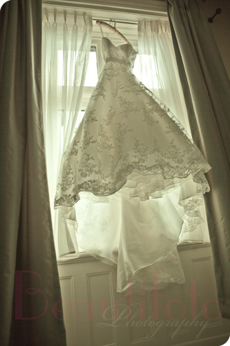 wedding dress hanging frmo the window