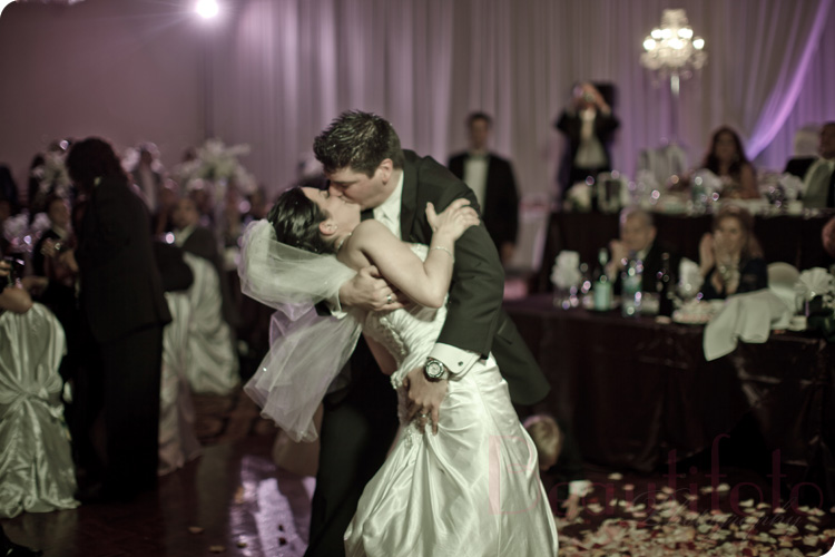 the bride and groom passionately kissing